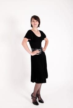 a young woman in strict black dress in studio looking like widow or nanny