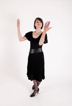 a young woman in strict black dress in studio looking like widow or nanny