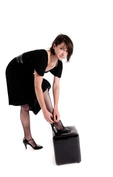 young brunette woman looking like a nanny or widow wearing a black shoe
