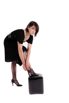young brunette woman looking like a nanny or widow wearing a black shoe