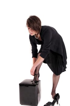 young brunette woman looking like a nanny or widow wearing a black shoe