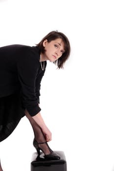 young brunette woman looking like a nanny or widow wearing a black shoe
