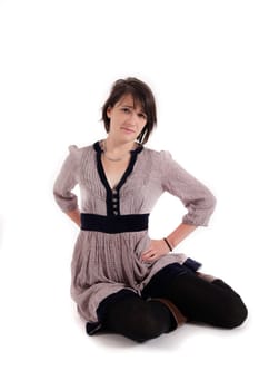 young brunette woman in dress sitting on the ground with boots