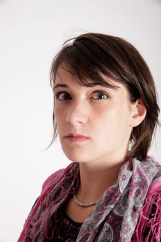 portrait of a young brunette woman with colored scarf looking ahead