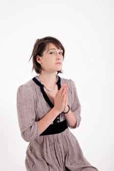 portrait of a young brunette woman requesting in catholic posture united hand