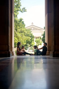 Education and students in university, group of young men and women talking and relaxing in college