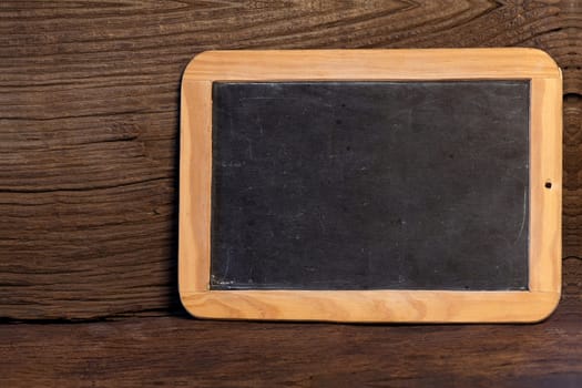 Old slate to label against a dark rustic wooden background