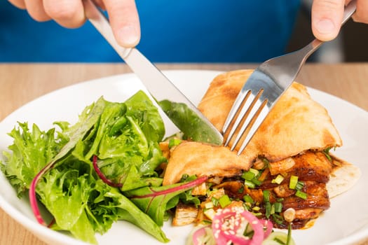 Pitta bread is going to cut by knife