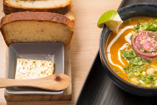 Ceramic bowl with delicious soup and melted butter