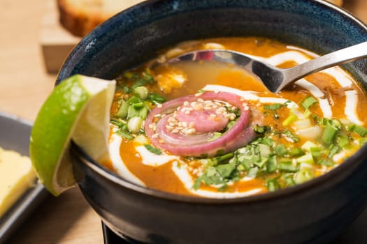 Zoomed bowl with soup and spoon in it