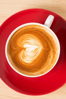 Cup of coffee with heart illustration from foam