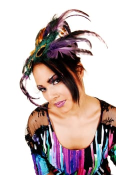 A young woman in a colorful blouse with a father mask on her forehead in a portrait shoot, looking into the camera, on white background.