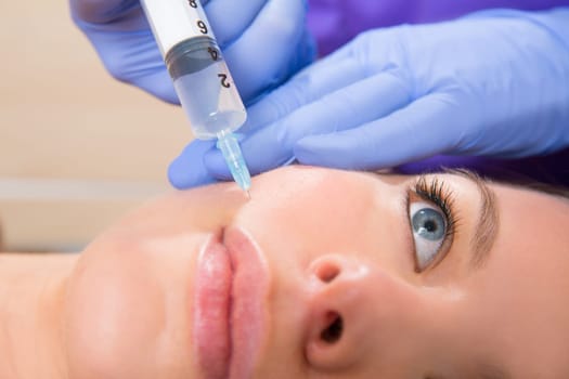 Anti aging facial mesotherapy with syringe closeup  on woman face