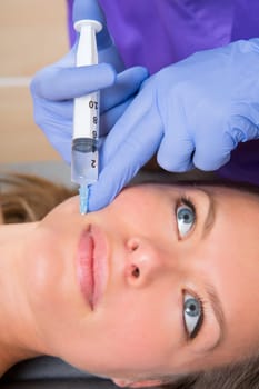 Anti aging facial mesotherapy with syringe closeup  on woman face rictus