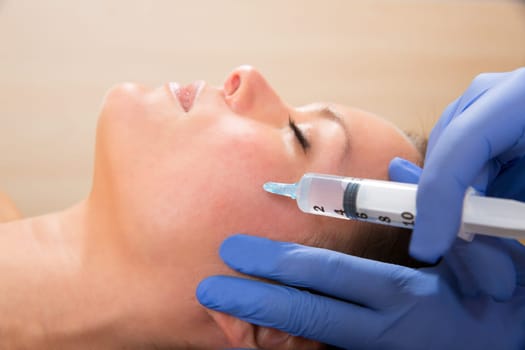 Anti aging facial mesotherapy with syringe closeup  on woman face