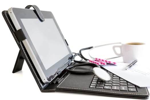 Digital tablet pc , pills and stethoscope, health concept on white background