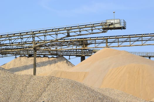 Mountains of gravel and sand in the gravel plant