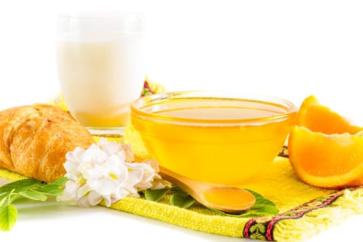 Breakfast with honey, milk and oranges
