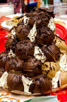 cake with cream and chocolate profiteroles in Sicily