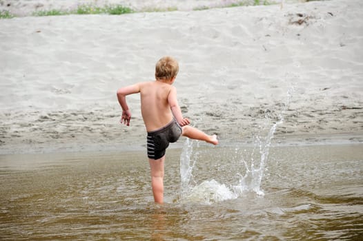 boy is playng in water