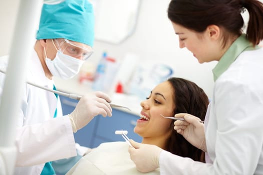 Pretty patient undergoing a dental check