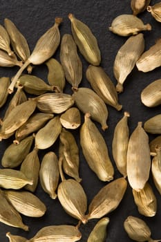 cardamom pods on black background macro closeup