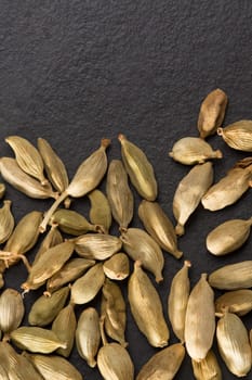 cardamom pods on black background macro closeup