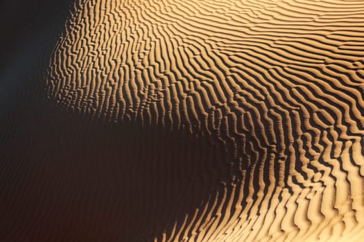 Sand pattern with deep shadows in the Sahara desert of Morocco.