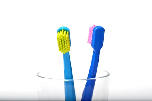 Colorful toothbrushes in a glass