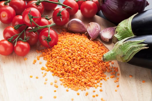 Ingredients for red lentil curry with aubergine and cherry tomatoes.