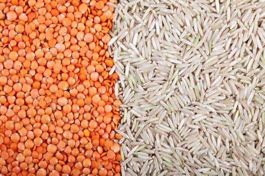 Food background with red lentils and brown basmati rice vertical orientation.