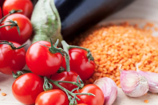 Ingredients for red lentil curry with aubergine and cherry tomatoes.
