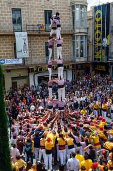 BARCELONA, SPAIN - MAY 19: Some unidentified people called Castellers do a Castell or Human Tower, typical tradition in Catalonia, on May 19, 2013 in Barcelona, Spain.