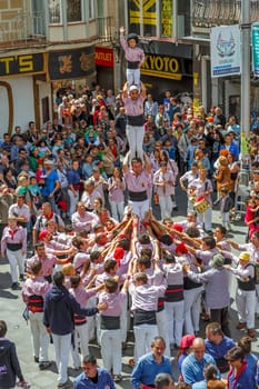 BARCELONA, SPAIN - MAY 19: Some unidentified people called Castellers do a Castell or Human Tower, typical tradition in Catalonia, on May 19, 2013 in Barcelona, Spain.