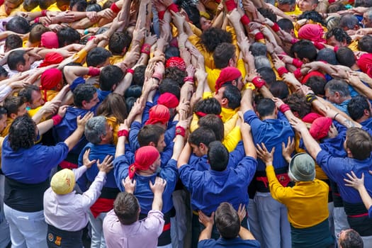 BARCELONA, SPAIN - MAY 19: Some unidentified people called Castellers do a Castell or Human Tower, typical tradition in Catalonia, on May 19, 2013 in Barcelona, Spain.