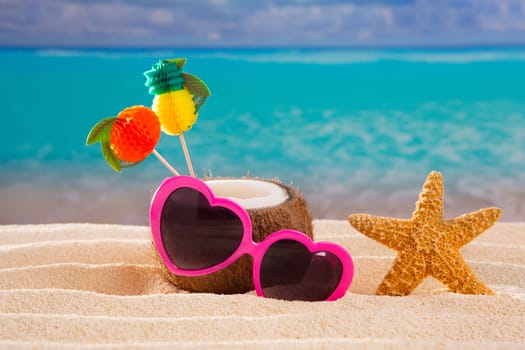 Coconut cocktail on tropical white sand beach heart shape funny sunglasses