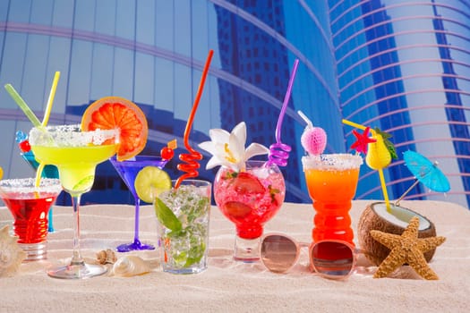 Colorful tropical cocktails in summer at urban city buildings