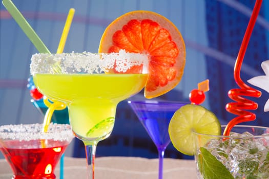 Colorful tropical cocktails in summer at urban city buildings