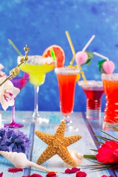 colorful mixed cocktails in tropical blue wood flowers starfish