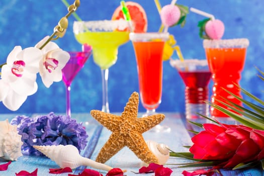 colorful mixed cocktails in tropical blue wood flowers starfish