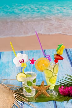 Mojito and lemon lime Cocktails in tropical blue wood at turquoise Caribbean beach