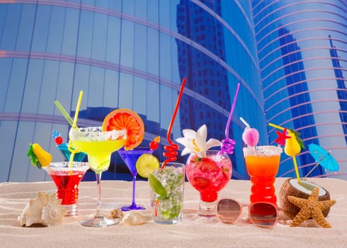 Colorful tropical cocktails in summer at urban city buildings