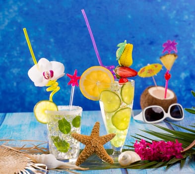 Mojito and lemon lime Cocktails in tropical Caribbean blue wood with starfish flowers and coconut