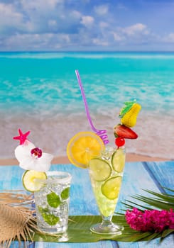 Mojito and lemon lime Cocktails in tropical blue wood at turquoise Caribbean beach