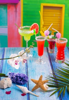 Cocktails margarita sex on the beach in colorful tropical house with flowers starfish and seashells
