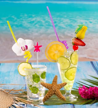 Mojito and lemon lime Cocktails in tropical blue wood at turquoise Caribbean beach