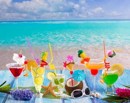 Colorful many tropical Cocktails in tropical blue wood at turquoise beach with coconut mojito margarita