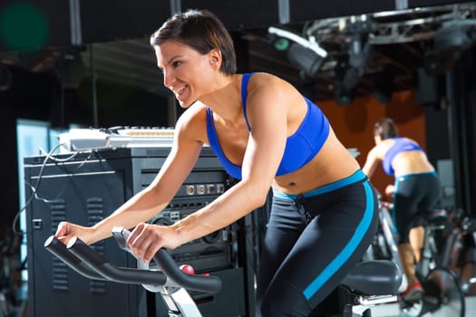 Aerobics spinning monitor trainer woman at gym at trainning class
