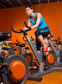 Aerobics spinning woman exercise workout at orange bikes gym