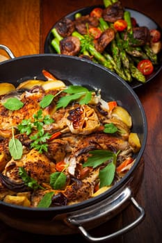 Roasted roasted rabbit on vegetables in pan